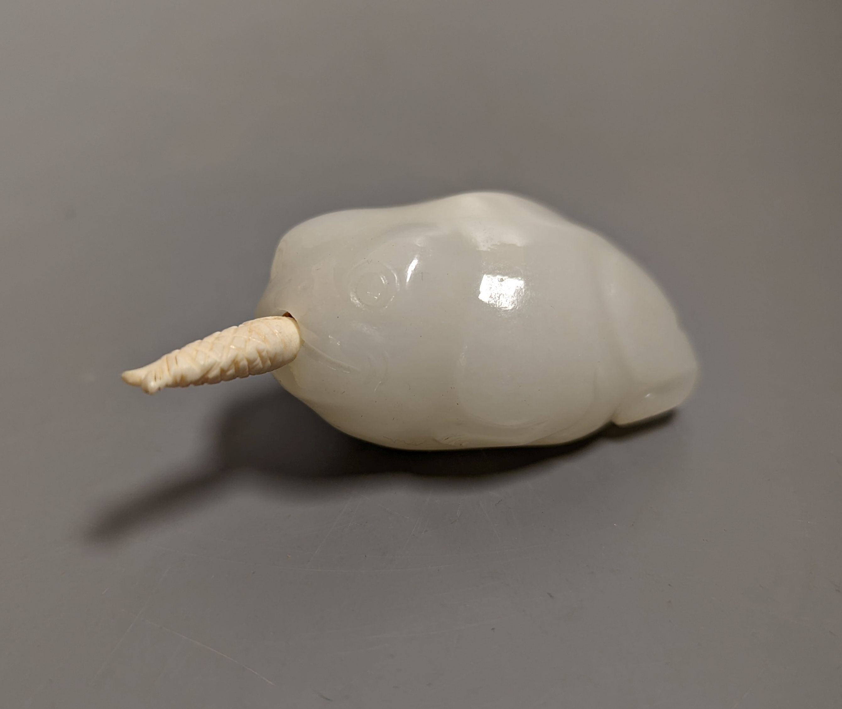 A Chinese white jade 'toad' snuff bottle, the stone of excellent even tone, 8cms long, including stopper